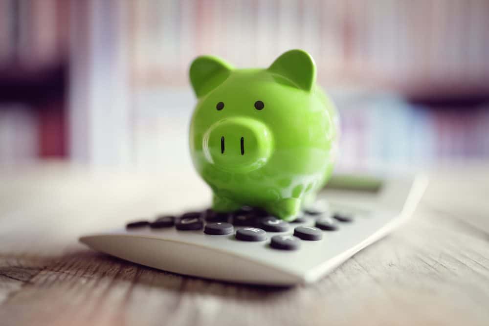 Piggy bank on calculator concept for saving, accounting, banking and business account